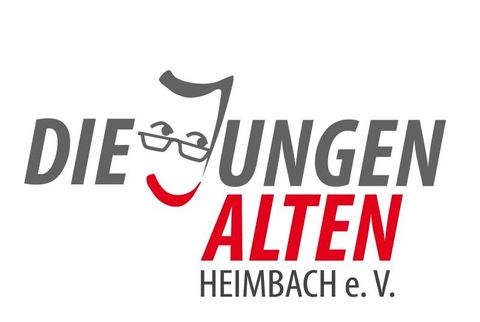 Ein Logo der Gruppe "Die Jungen Alten" aus Heimbach e.V. mit einer stilisierten Gesichtsdarstellung. Die Farben Rot und Grau dominieren, mit einem freundlichen Ausdruck.