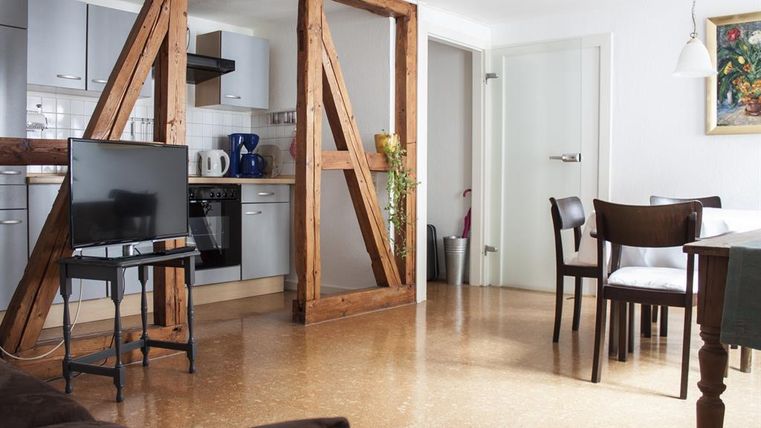 Eine gemütliche Wohnung mit einer offenen Küche und modernem Mobiliar. Der Wohnbereich ist hell und einladend, ideal für Entspannung und geselliges Beisammensein.